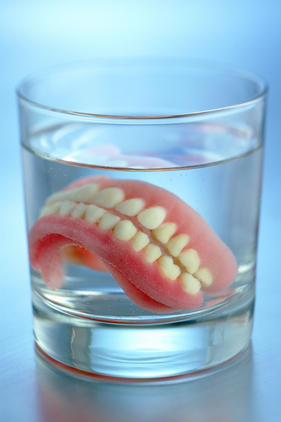 fake teeth in glass of water